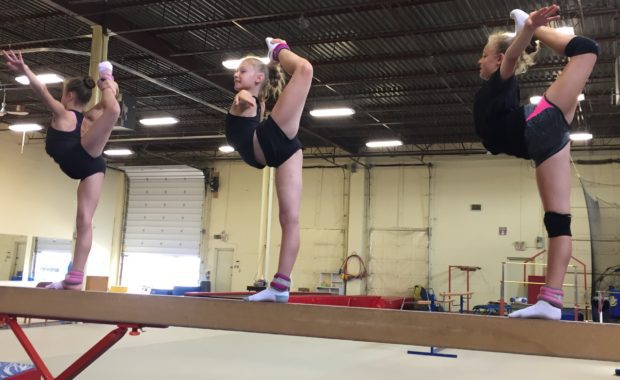 back balance with gymnast on a beam