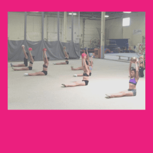 competitive gymnasts training with rhythmic ball